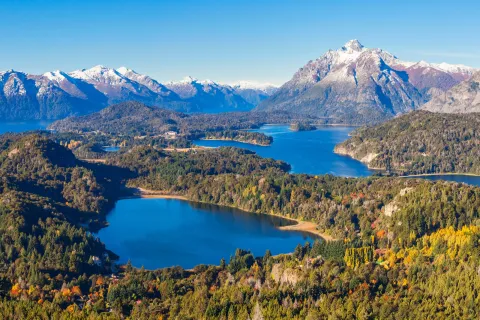 Multiple lakes surrounded by tall trees and mountains