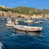 Coastal town and houses, boats scattered about.
