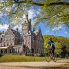 guests biking past beautiful building