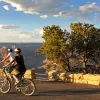 Two cyclists overlooking Grand Canyon.