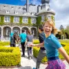 Guests walking towards stone building, one is smiling at camera.