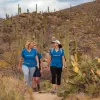 Women hikers in blue backroads shirts talking 