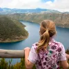 Child looking over a railing at an island