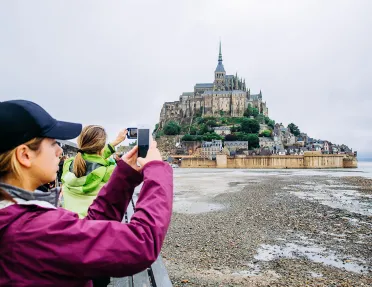 Backroads Guests Taking Photos of Le Mont Saint-Michel Tidal Island 
