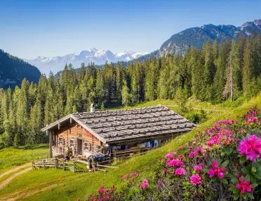 a wood house nestled in green hills