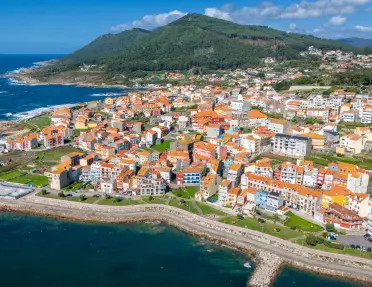 The coastal town of A Guarda in Galicia, Spain, featuring numerous buildings with distinctive orange rooftops.