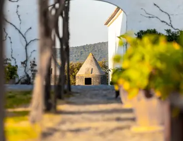 A stone dwelling featuring a distinctive conical roof.