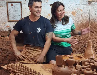 Two Backroads guests in a terracotta pottery workshop in Portugal.