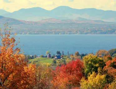 Vibrant fall foliage of Vermont overlooking Lake Champlain.